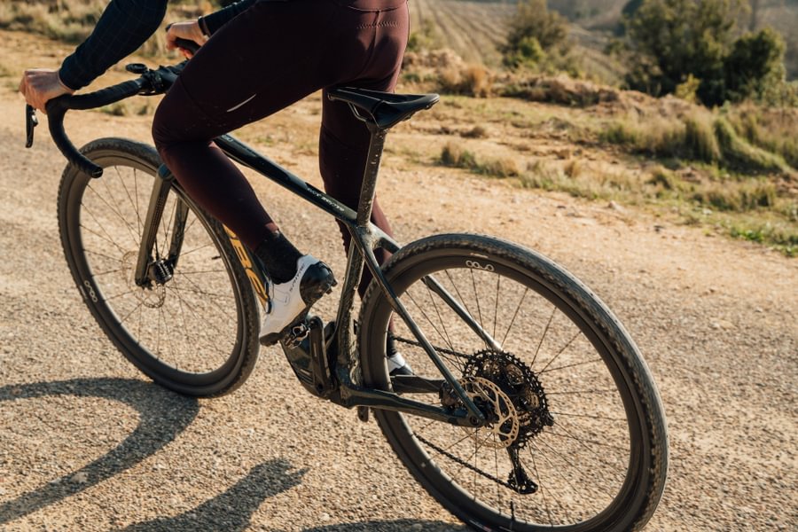 Close-up of a cyclist dancing on a gravel bike